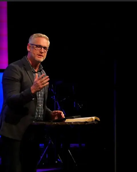 A pastor preaching from the stage, shot by a volunteer