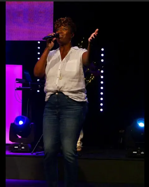 A vocalist mid-song during worship